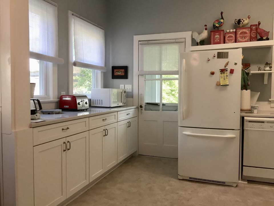 The kitchen is well equipped with dishes, serving pieces and cookware.