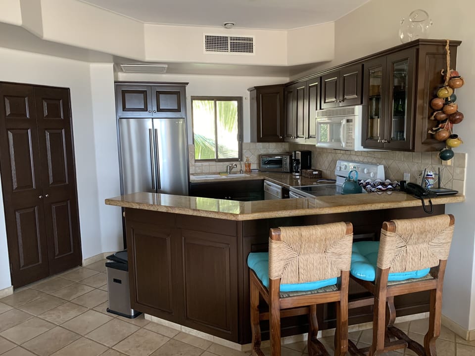 Two bar stools for casual dining. Washer & dryer also located in kitchen area.