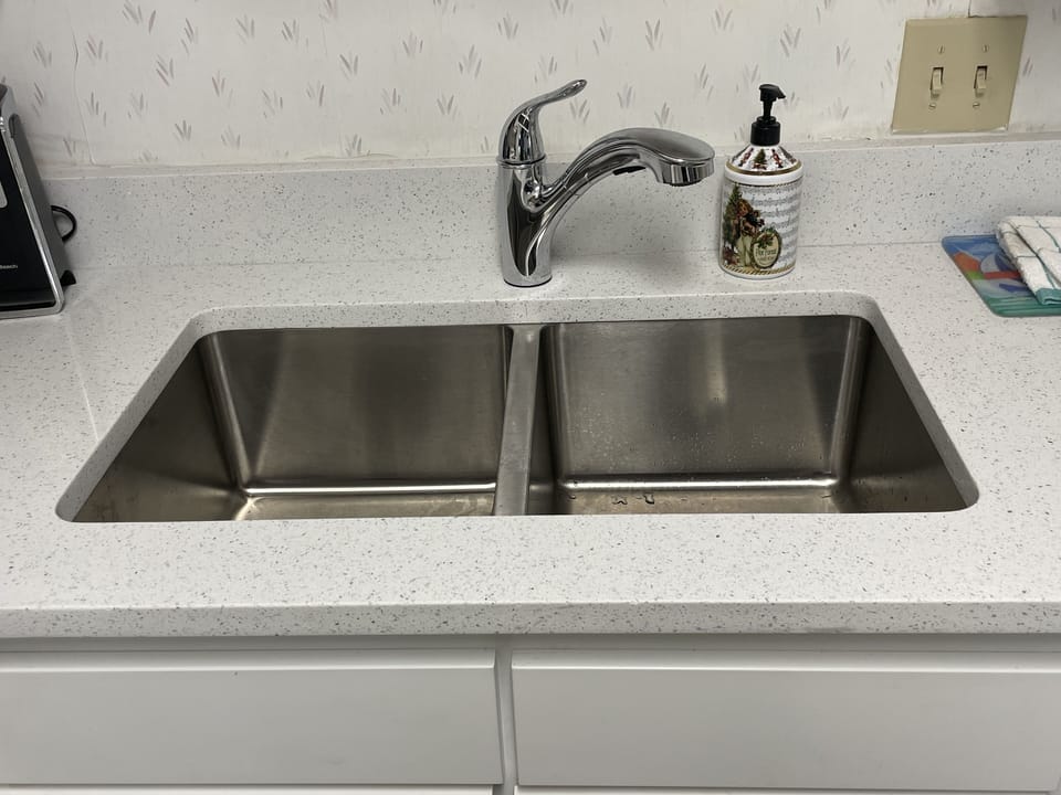 Kitchen with new countertops and new faucet.
