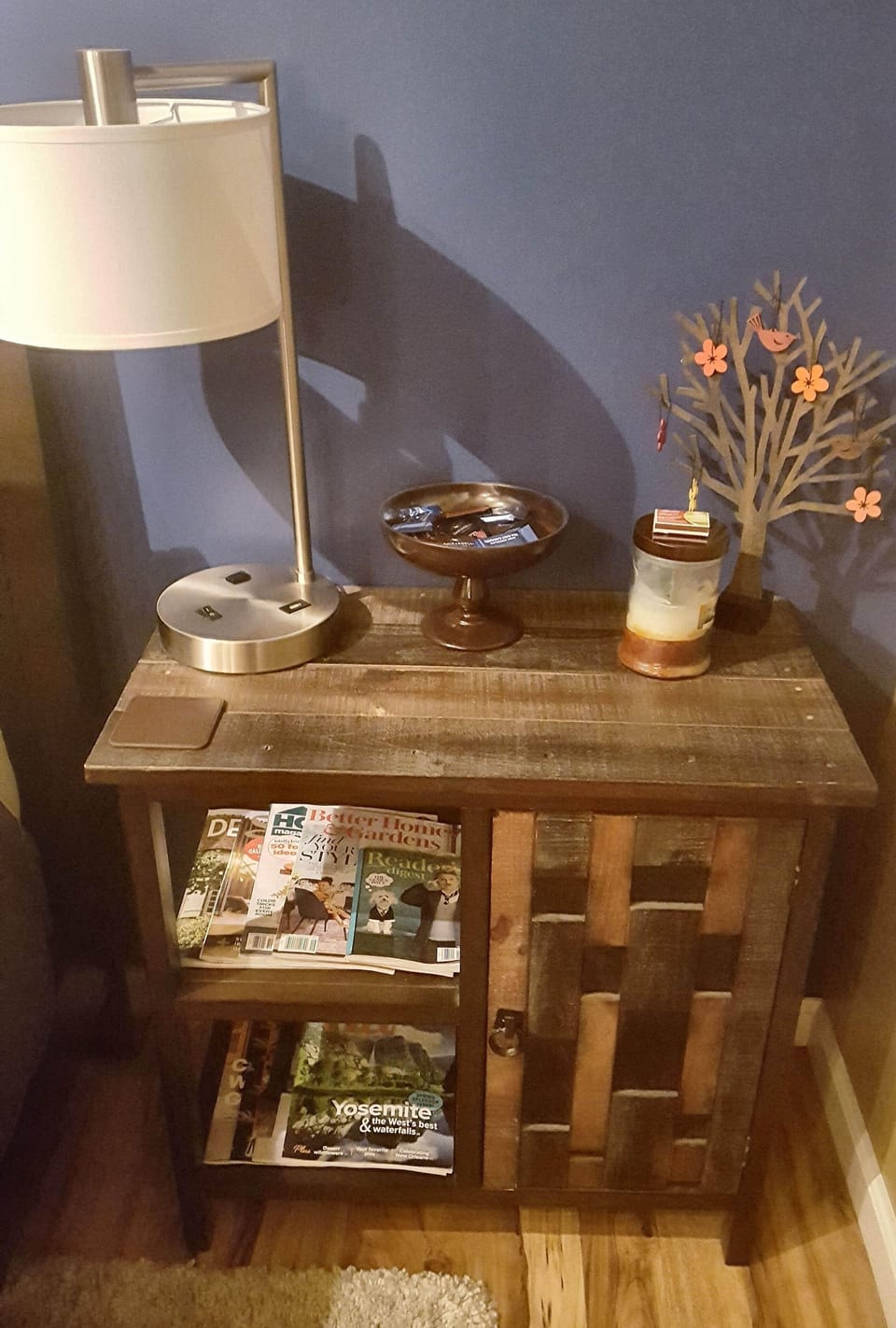 Night stand and book/magazine cabinet topped with bowl of chocolates!