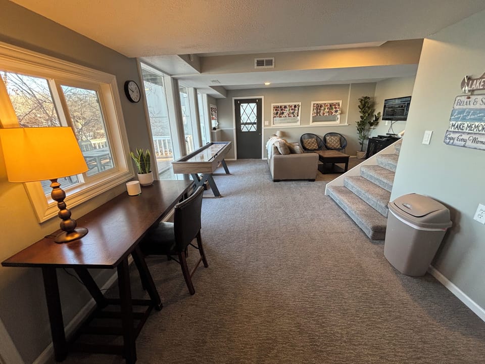 Basement living area with shuffleboard and pull out couch