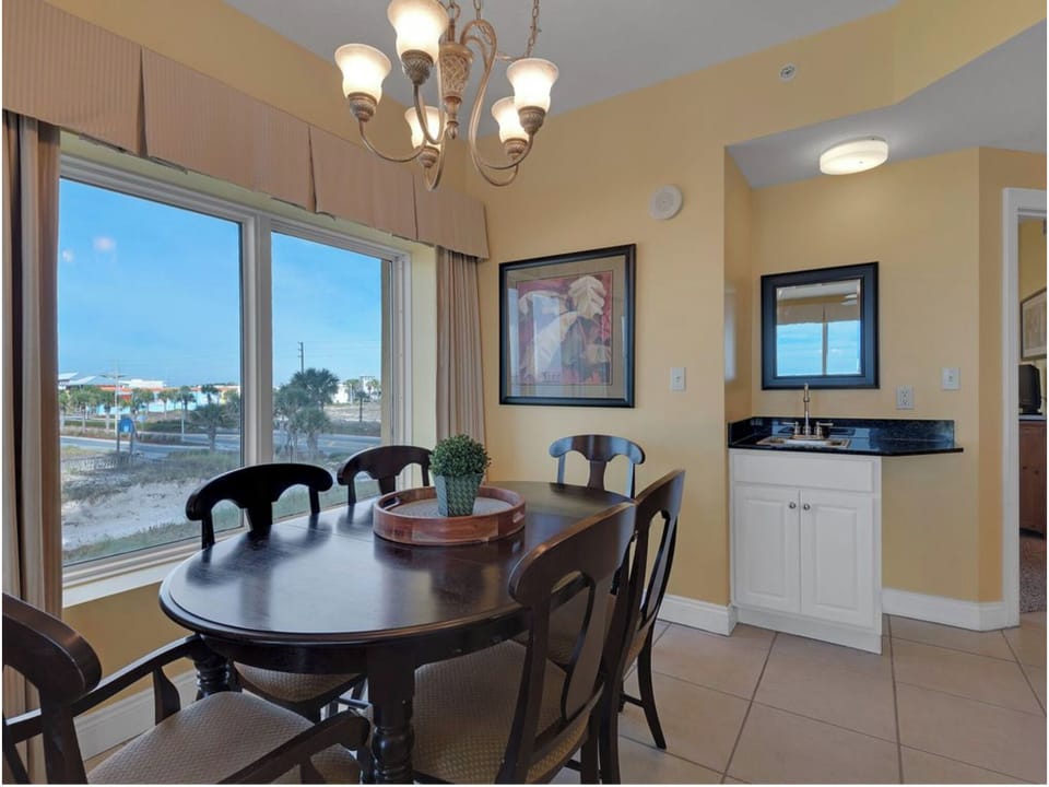 Gather around your elegant dining table for memorable meals while enjoying natural light through expansive windows overlooking the peaceful neighborhood.