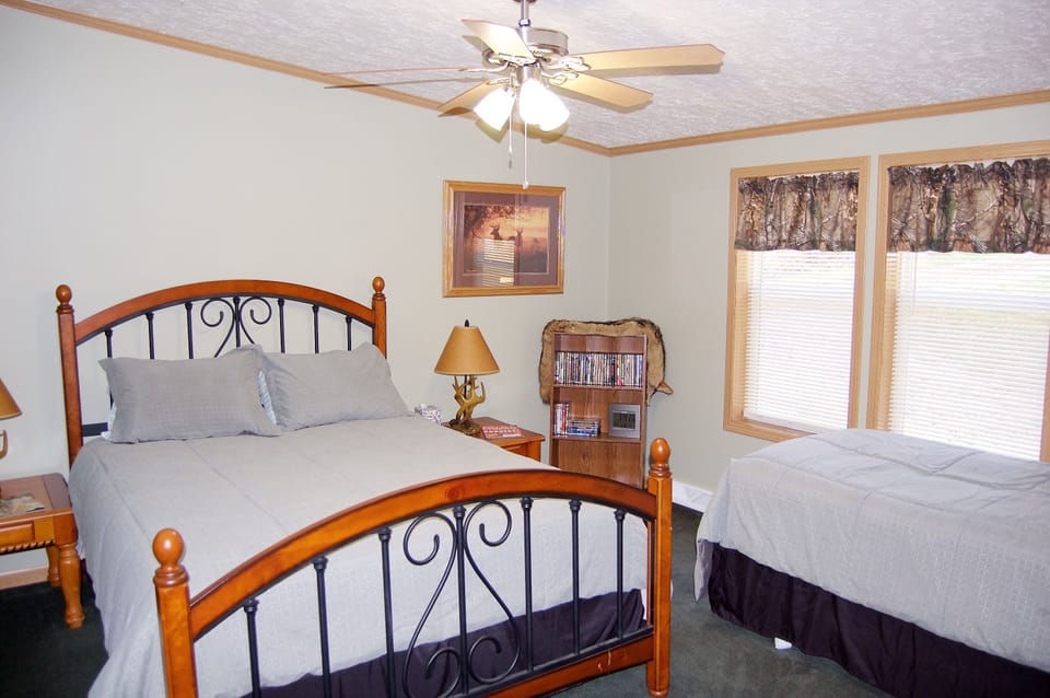 Master bedroom with queen and twin bed. Also has roll-away bed in walk-in closet