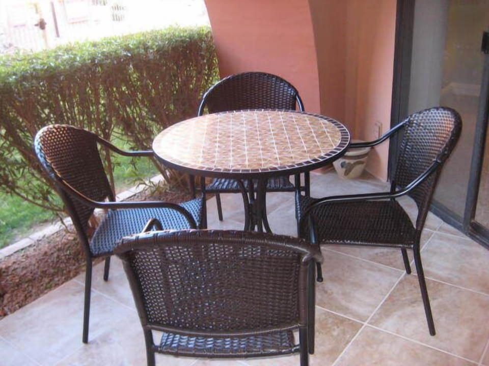 Patio seats four right out by the pool