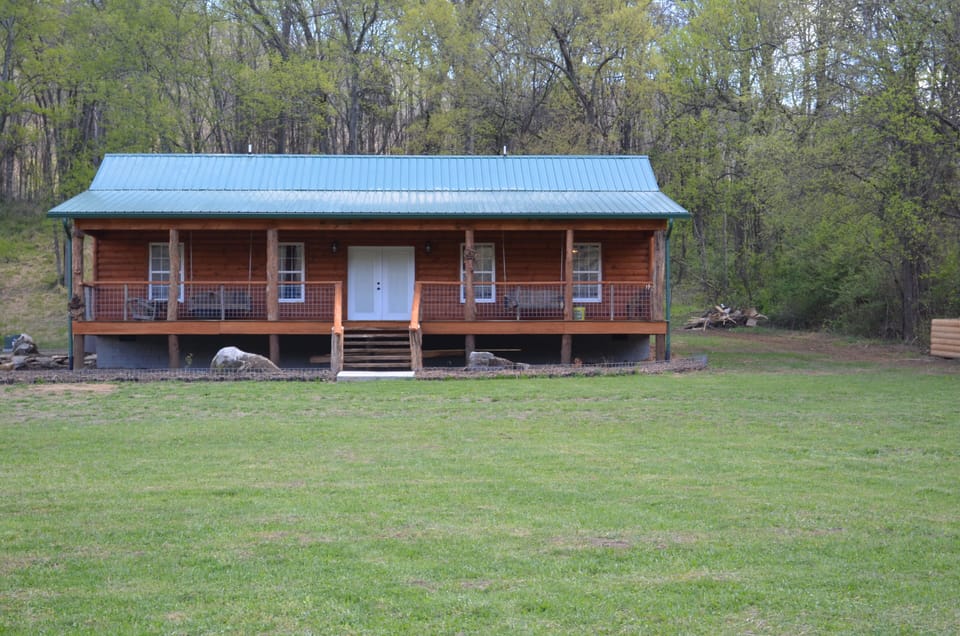 Front of cabin w/ 2 swings on front porch