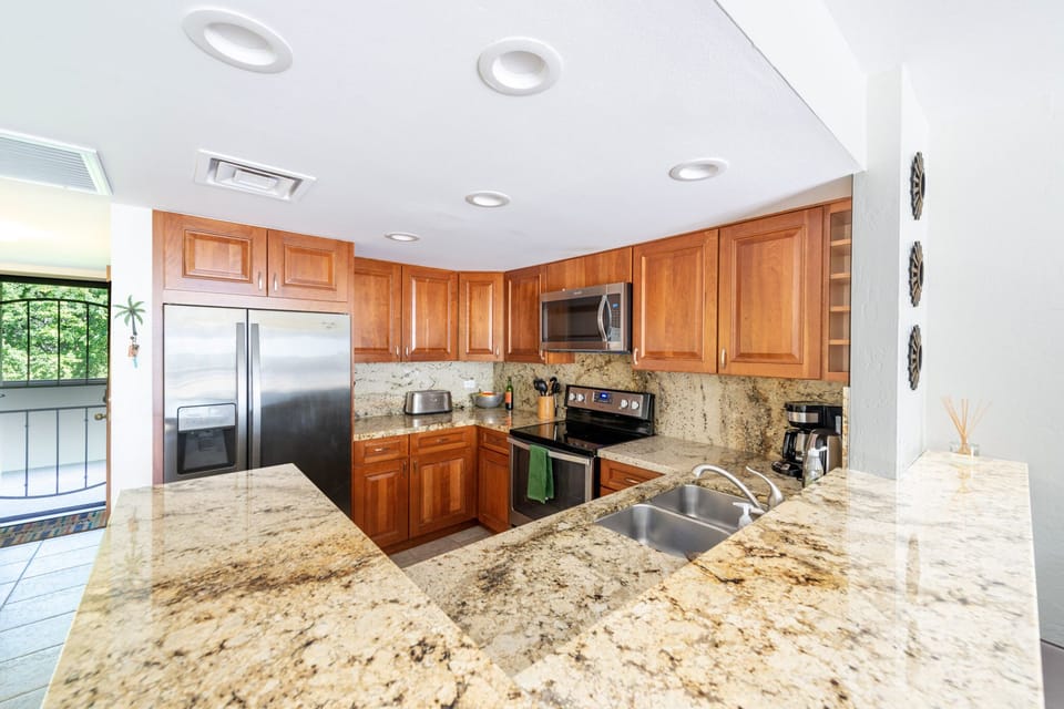 Updated kitchen with hand selected granite countertops and new appliances. 