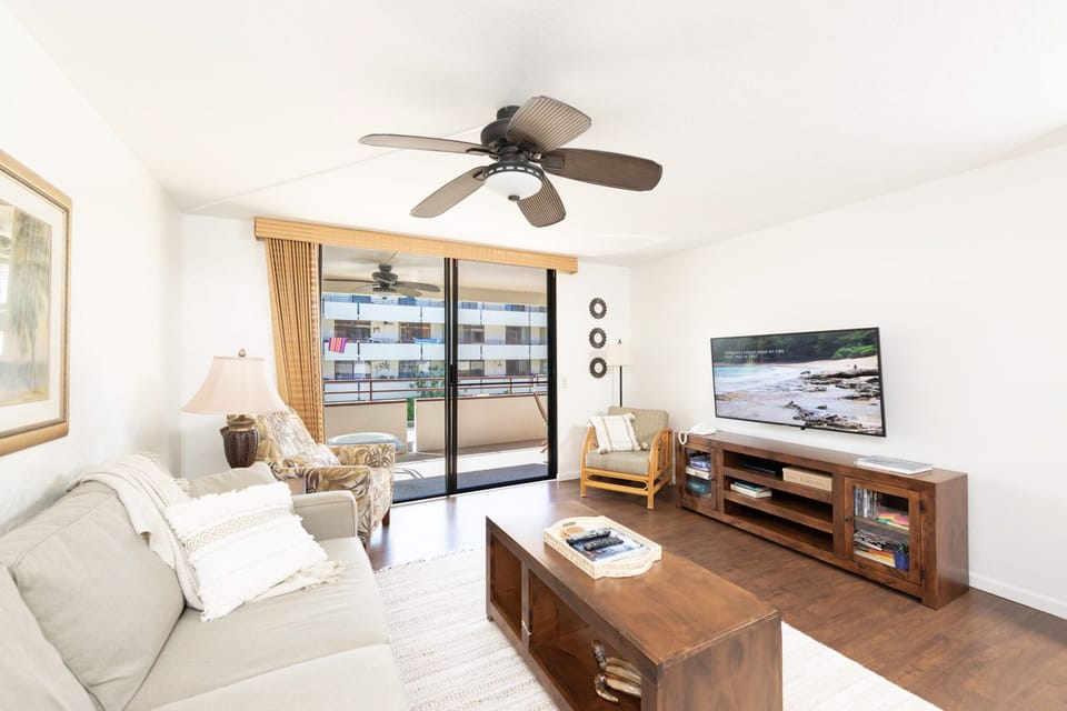 Living room with smart TV and lanai access. 
