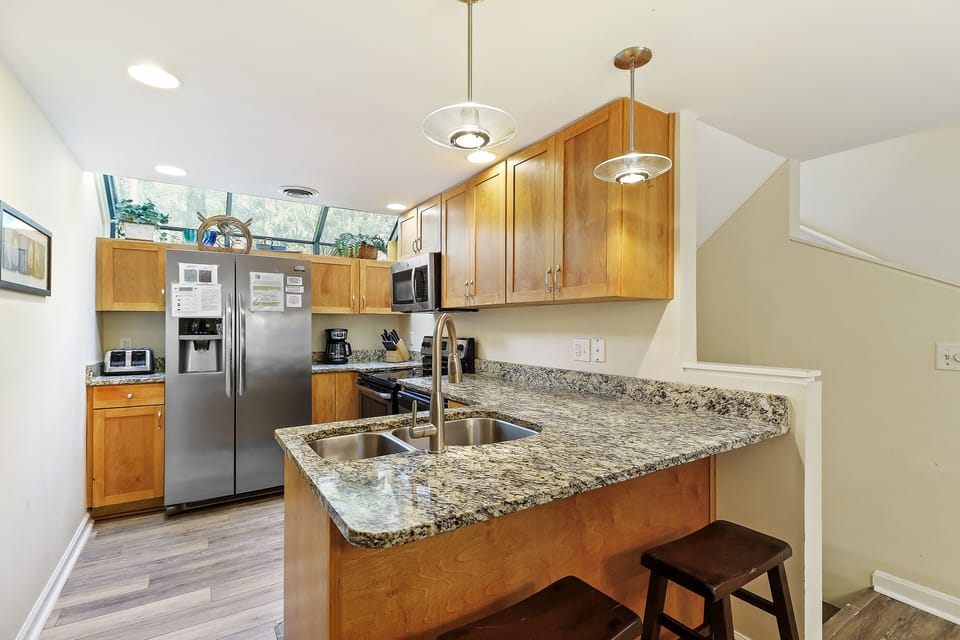 Updated kitchen with granite countertops, oak and stainless.