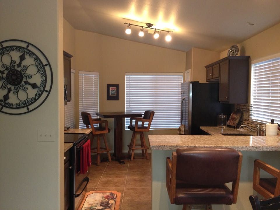 Kitchen with stainless appliances, breakfast bar coffee table