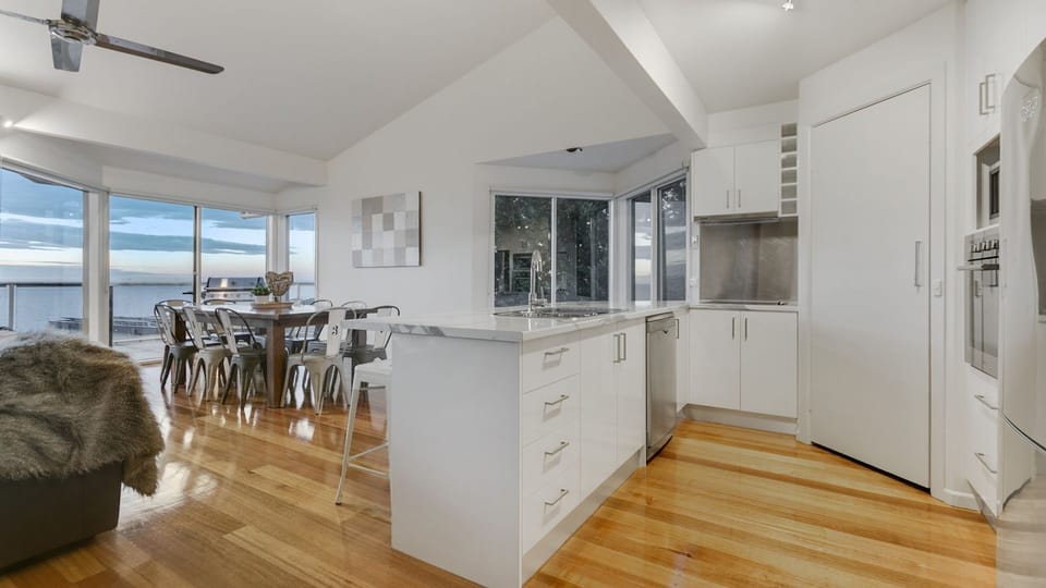 Well-appointed kitchen sharing stunning views with open-plan living