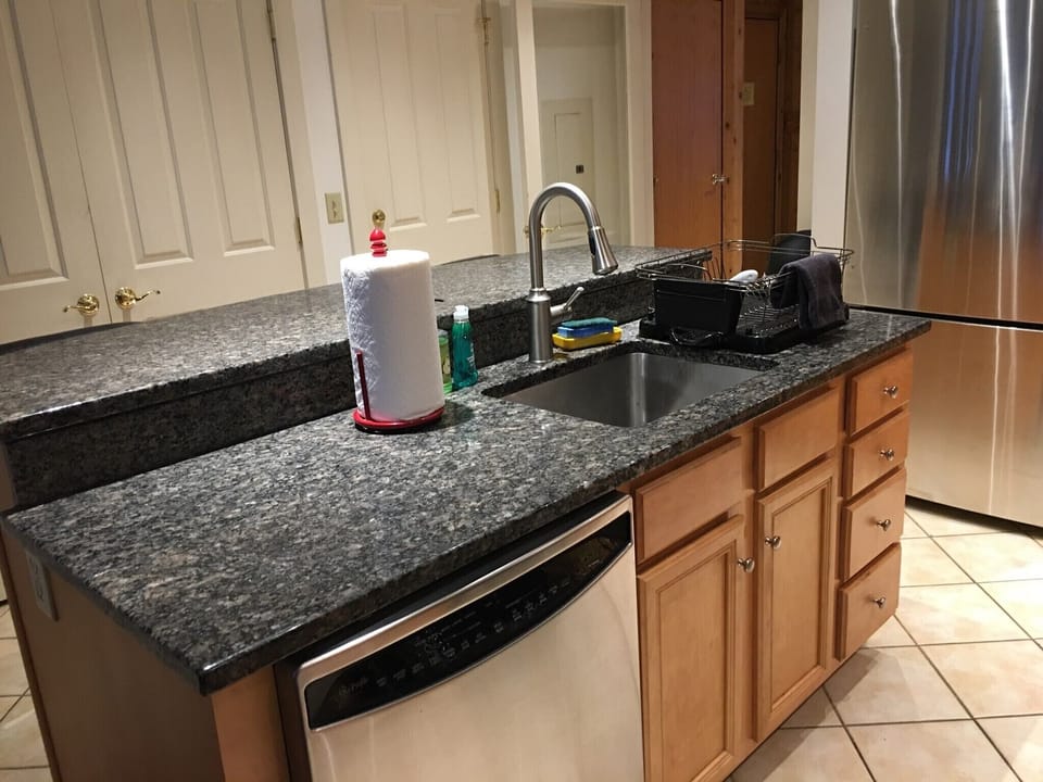 Kitchen with stainless steel appliances, granite counter tops, and tile floors.