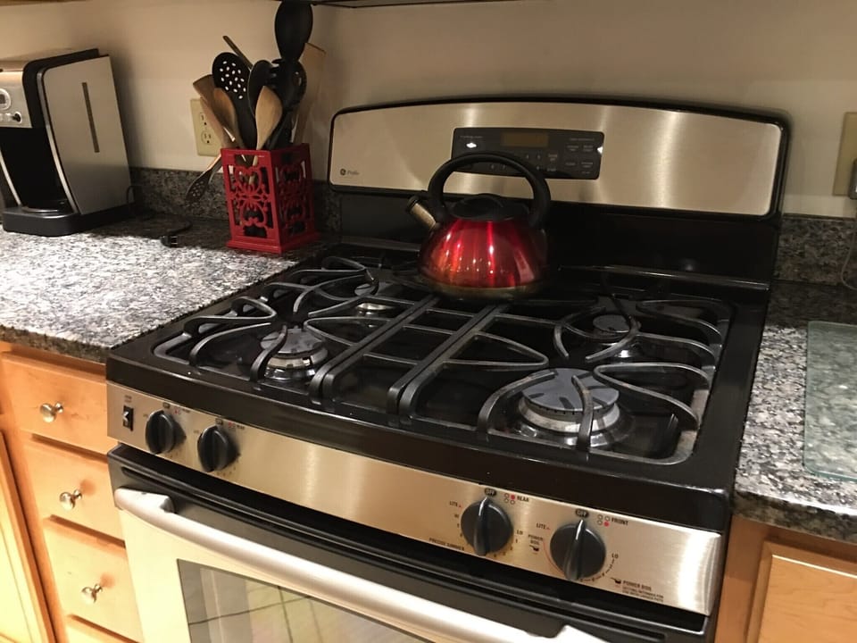 Kitchen with stainless steel appliances, granite counter tops, and tile floors.