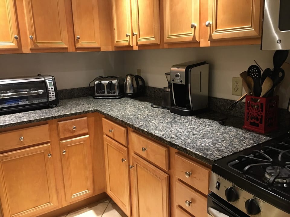 Kitchen with stainless steel appliances, granite counter tops, and tile floors.