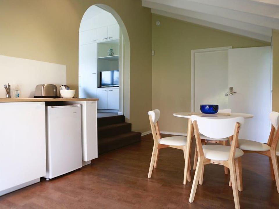 Dining and fully equipped kitchen with dishwasher, microwave, coffee maker.