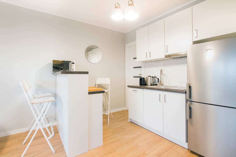 A view of the well-equipped kitchen in white.