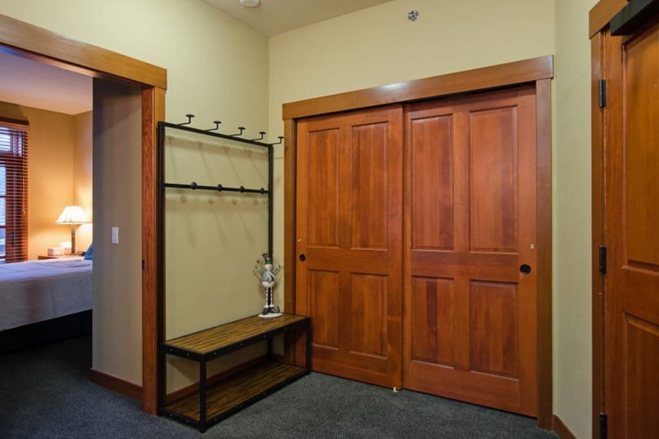Large entrance with drop zone and guest closet with organizers
