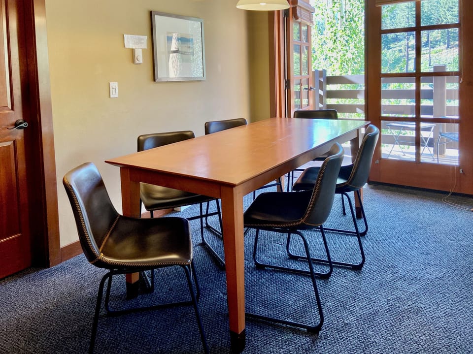 Dining table seats up to 8 guests with extra chairs from bedrooms