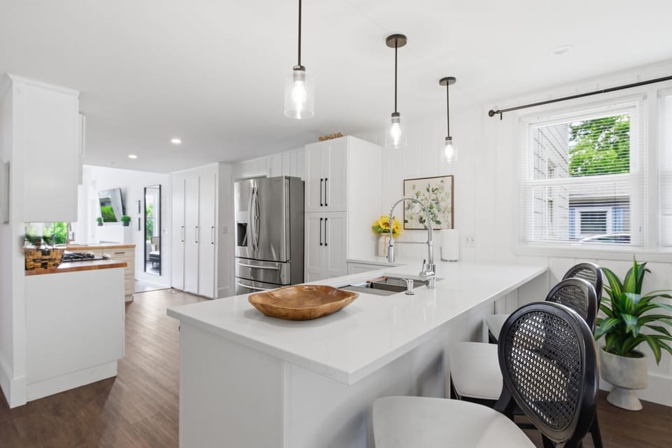 2026 Kitchen Remodel including new floors, cabinets, island, beverage refrigerator, furniture, and lighting.