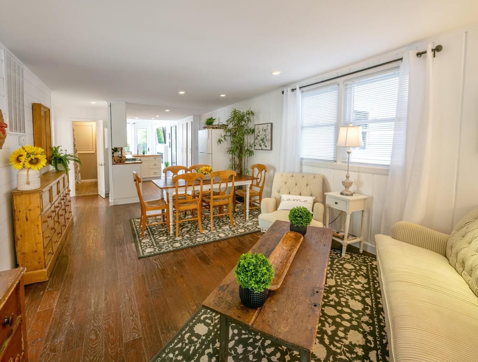 Enter into a a cozy living room and one of the two dining areas in this beautiful coastal house.