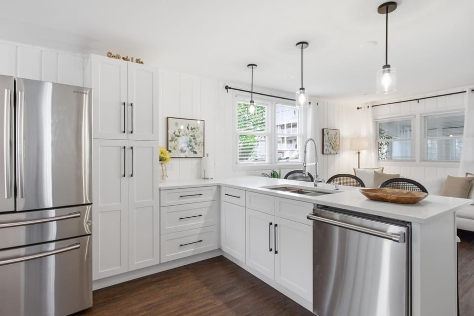 2026 Kitchen Remodel including new floors, cabinets, island, beverage refrigerator, furniture, and lighting.