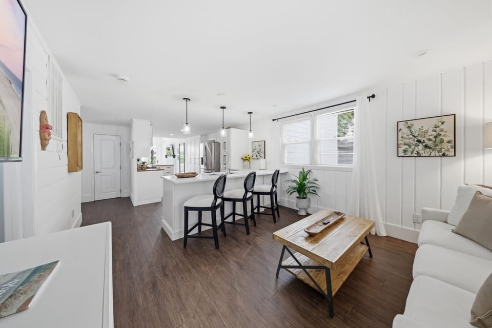 2026 Kitchen Remodel including new floors, cabinets, island, beverage refrigerator, furniture, and lighting.
