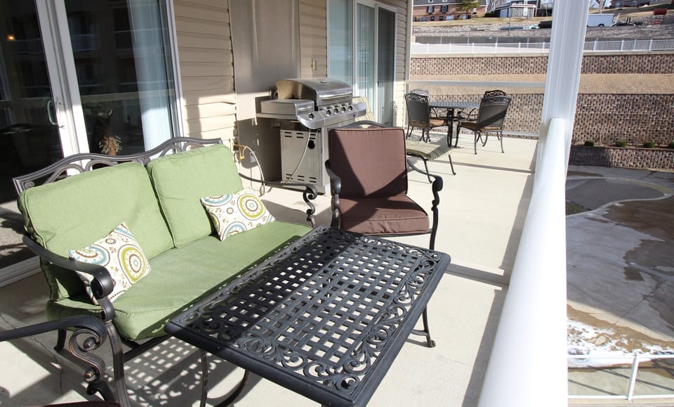 Spacious Deck with an End View of the Pool, Gas Grill, and Speaker System