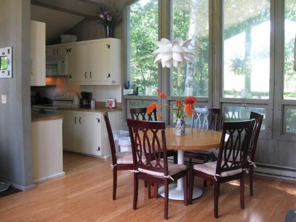 Dining area seats 6 with cathedral ceilings, bamboo floors, cool modern lighting