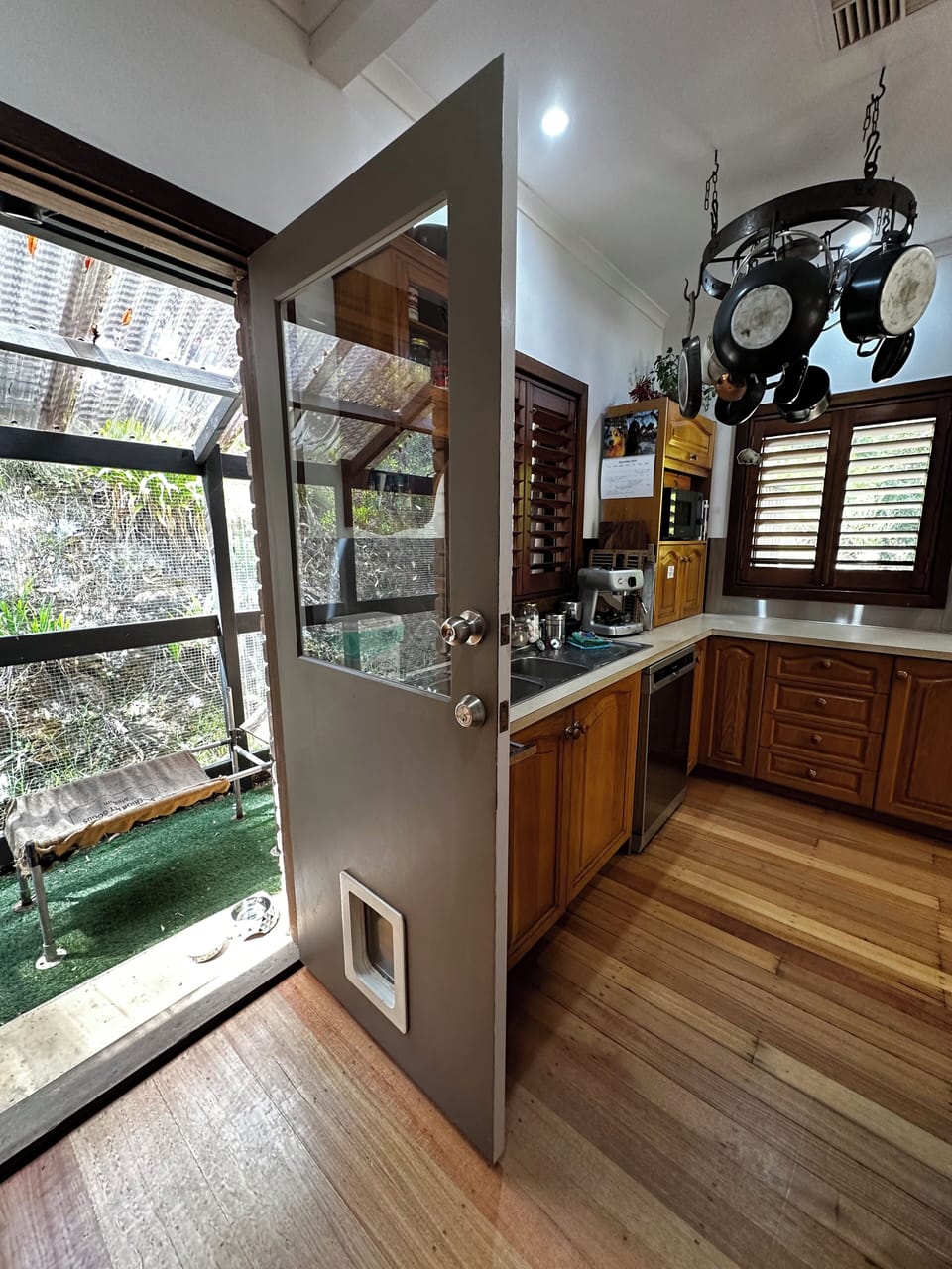 Kitchen door (with doggie door) leads to outdoor secure cat/small dog enclosure