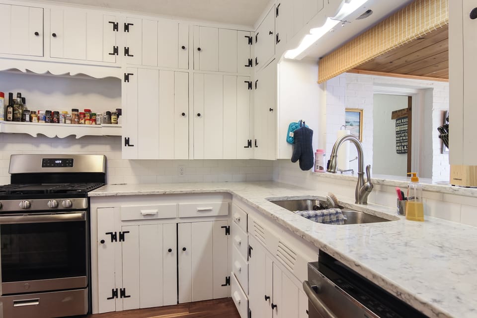 New kitchen with all stainless appliances, gas range and quartz countertops.