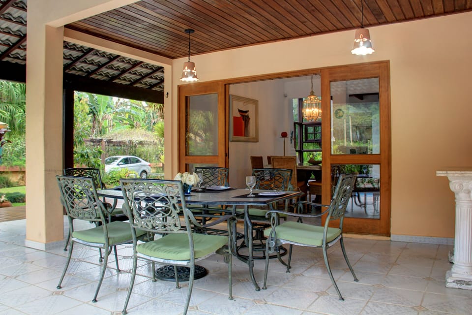 Mesa no terraço junto a piscina e churrasqueira 