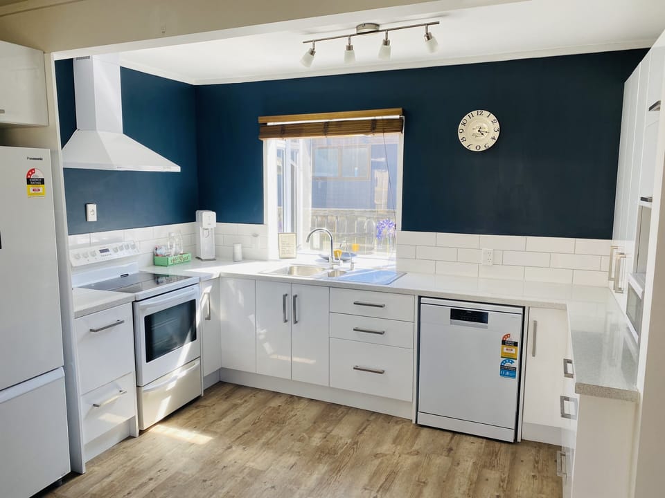 Modern kitchen with filtered tap water, dishwasher, microwave, hob/oven