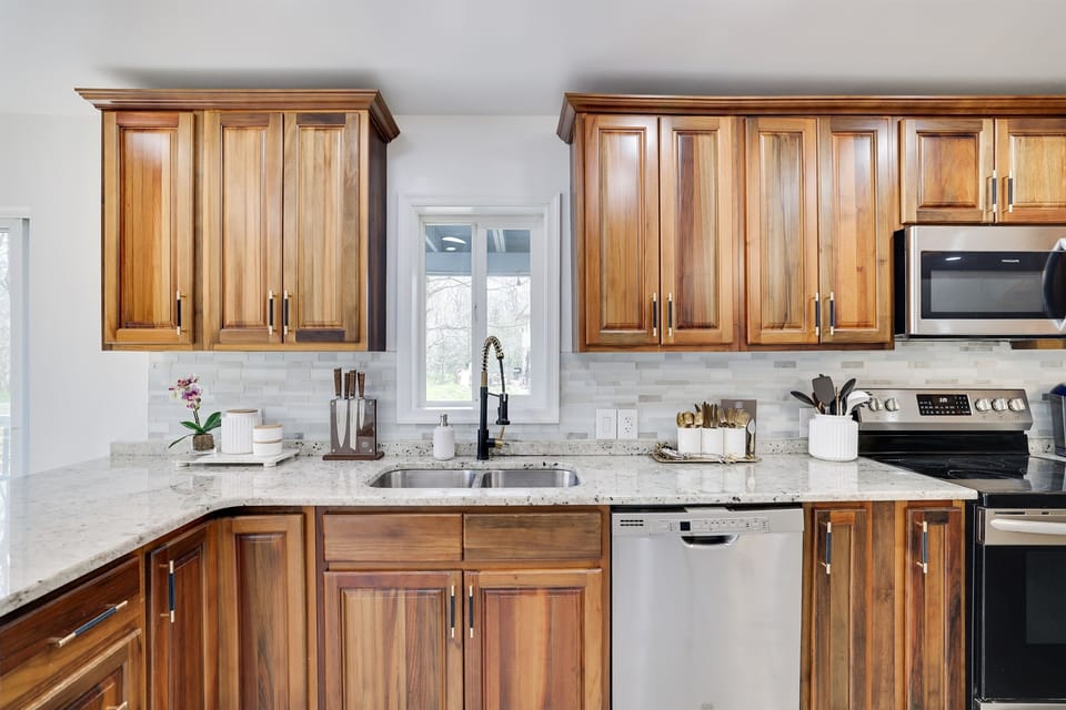 Fully Equipped Kitchen - The large kitchen boasts stainless steel appliances and essentials, including a coffee maker, French press, and Keurig. Cook like a pro and enjoy a meal together at your leisure.