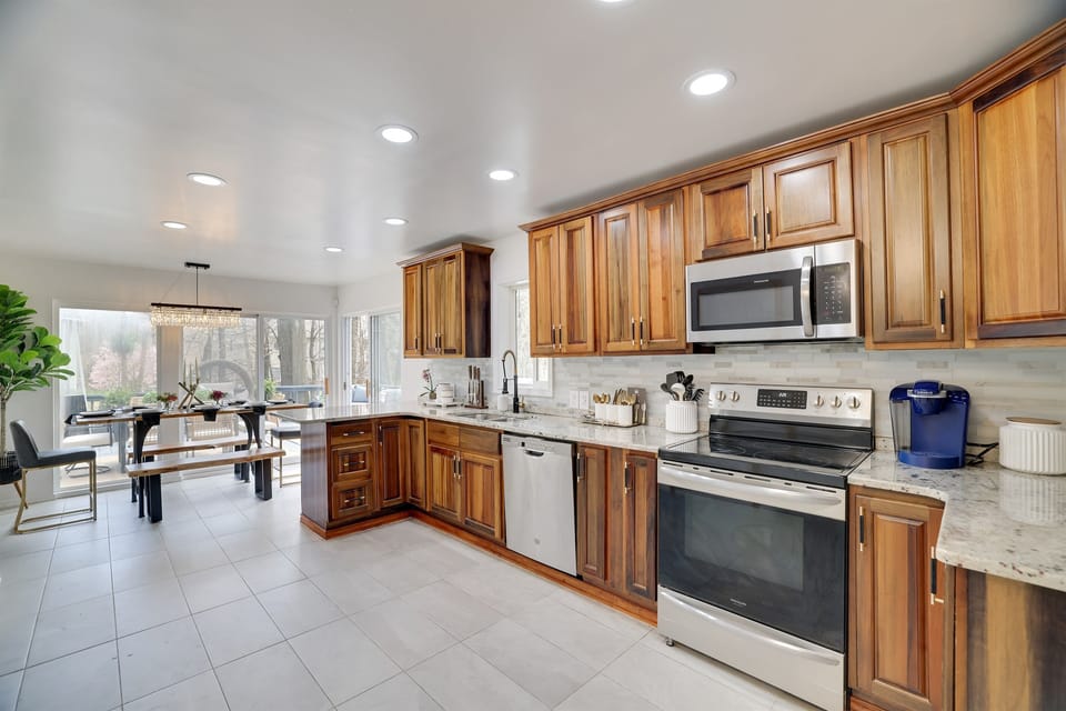 Fully Equipped Kitchen - The large kitchen boasts stainless steel appliances and essentials, including a coffee maker, French press, and Keurig. Cook like a pro and enjoy a meal together at your leisure.