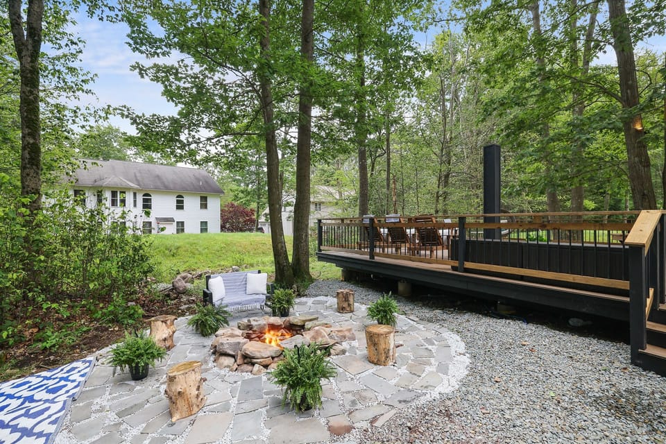 Backyard Firepit Area - Gather with loved ones under enchanting string lights around a cozy firepit. Perfect for roasting marshmallows and enjoying evening conversations.