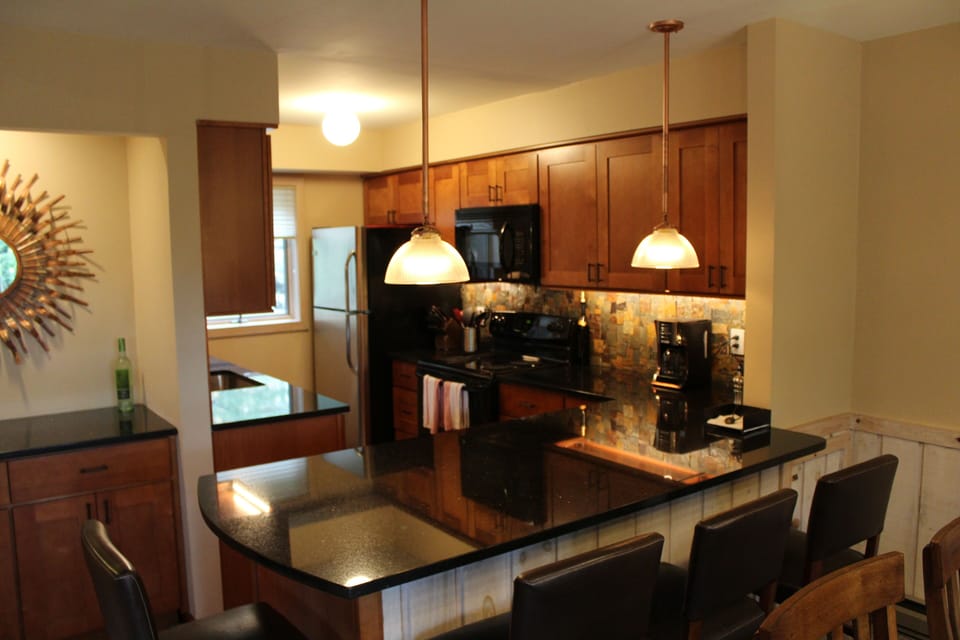 Gourmet kitchen has custom maple cabinets with granite countertops.