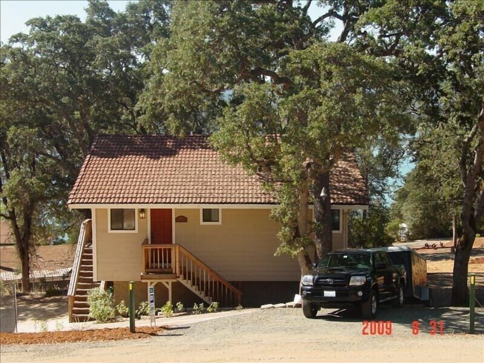 Front of Heron's Nest Nestled in Oaks.