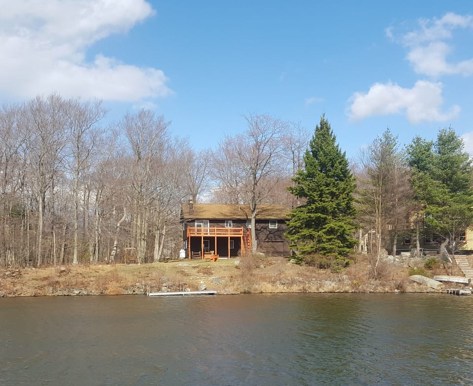 View of the back of the house from the other side of the lake.
