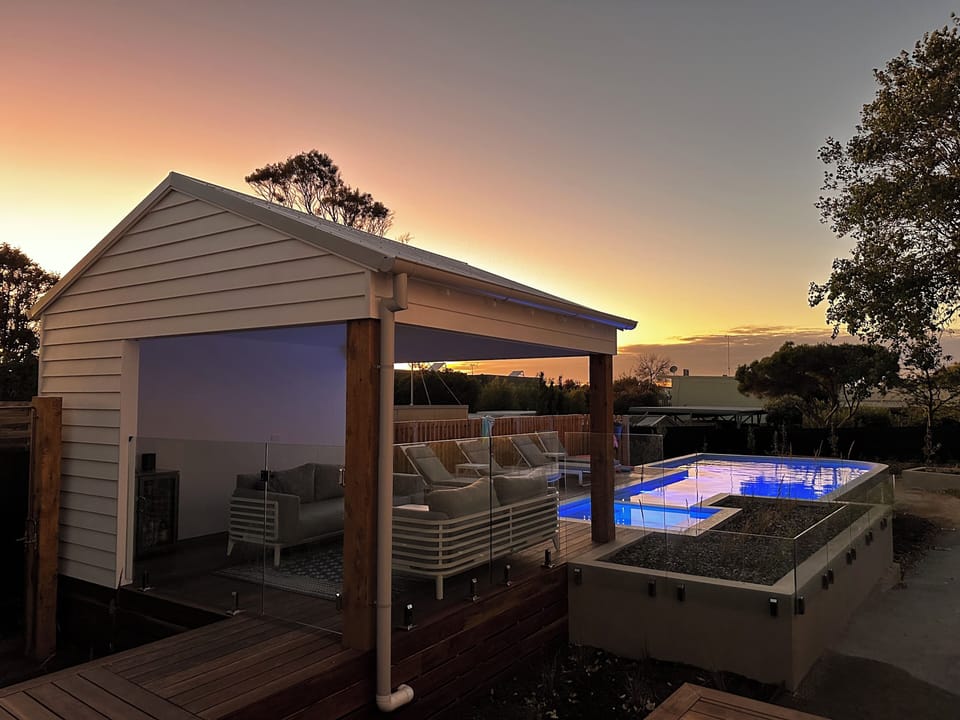 Sunrise over pool house and pool