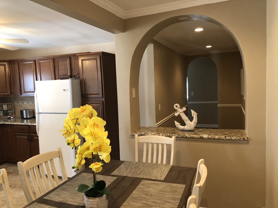 Dining area in kitchen looking towards hallway leading to bedrooms