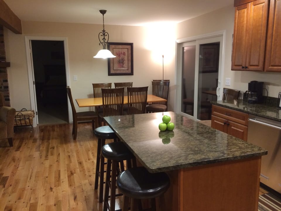 Dining table for 8 (addtl chairs avail) & 4 stools. Slider door to hottub.