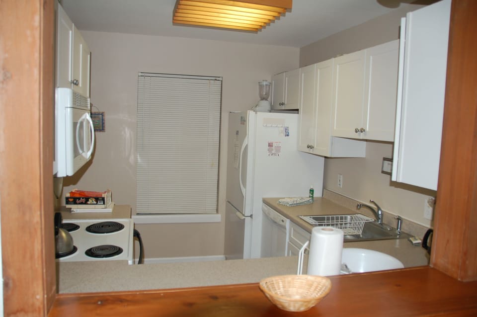 View into kitchen from living room wall cut-out