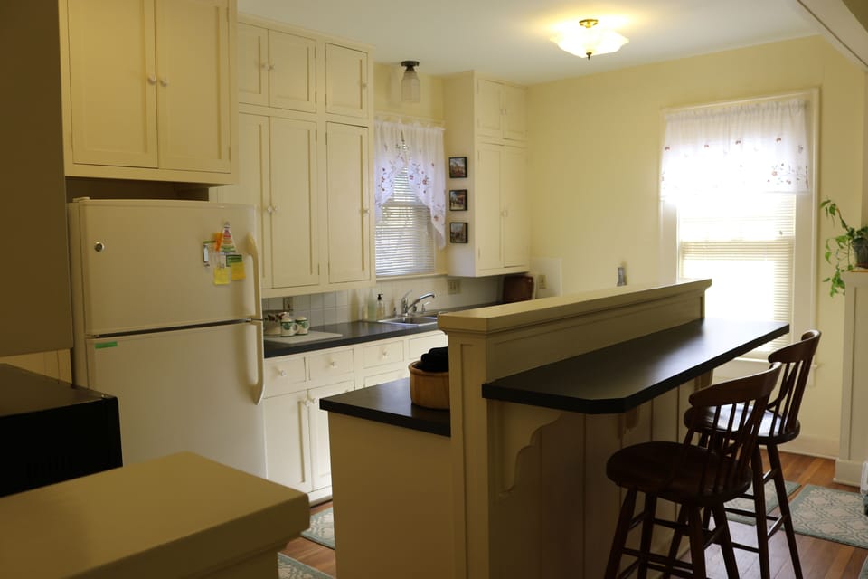 Restored kitchen with high ceiling, original oak floor and premium appliances.