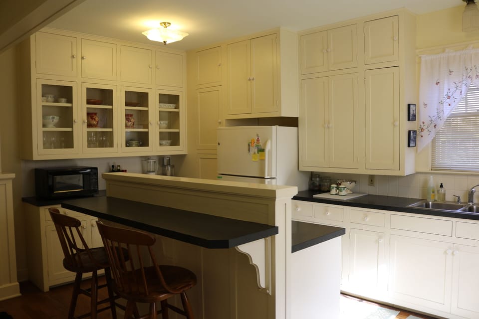 Beautifully restored kitchen with 34 cupboards packed with pots, pans & gadgets.