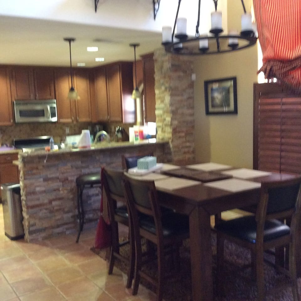 Dining room area with kitchen in the background.