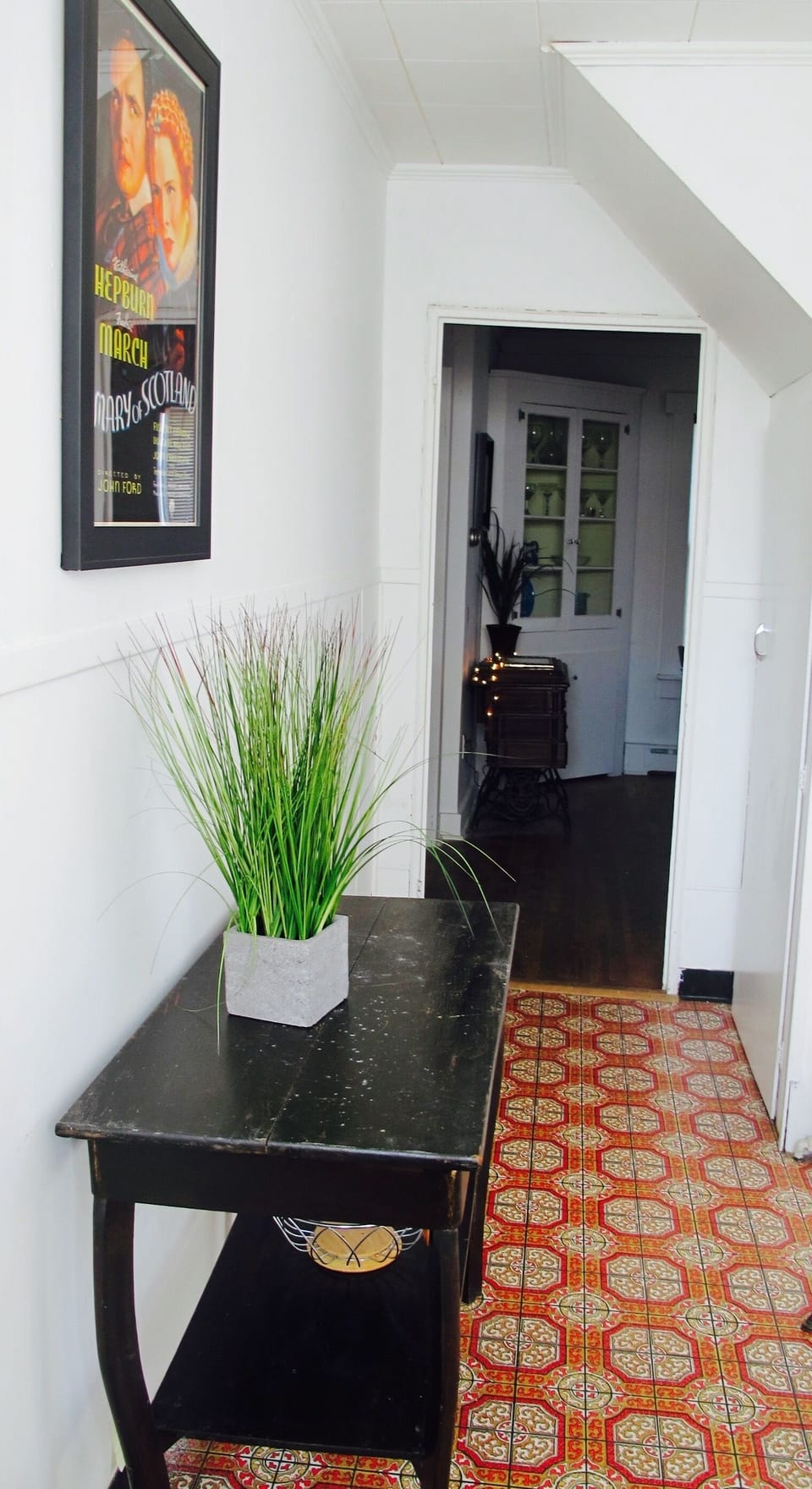 Entrance from dining rm. to kitchen. Note posters from John Ford movies on walls