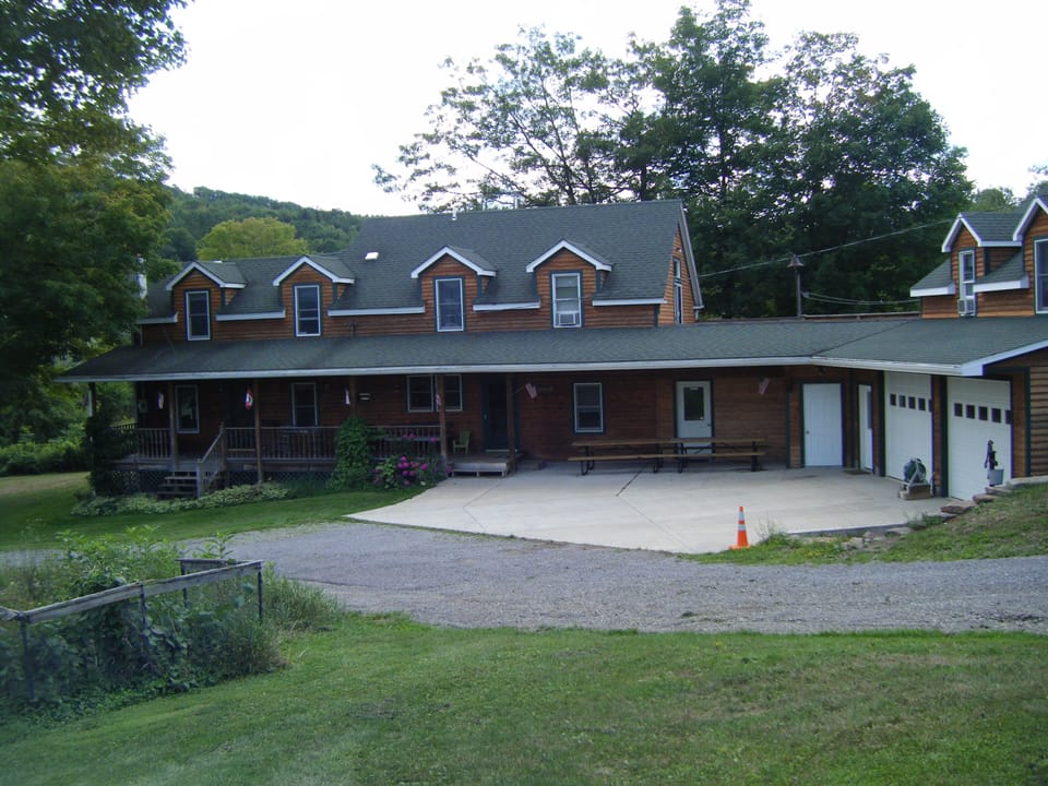 Enormous covered porch with 16’0 of picnic tables and additional seating for 16