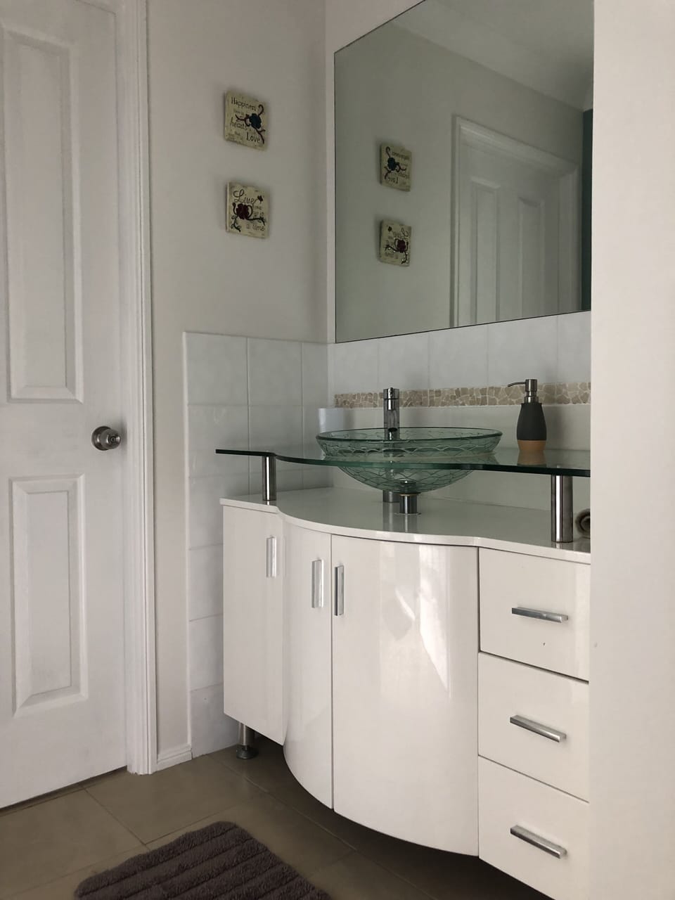 Open plan bathroom basin area with door to lavatory