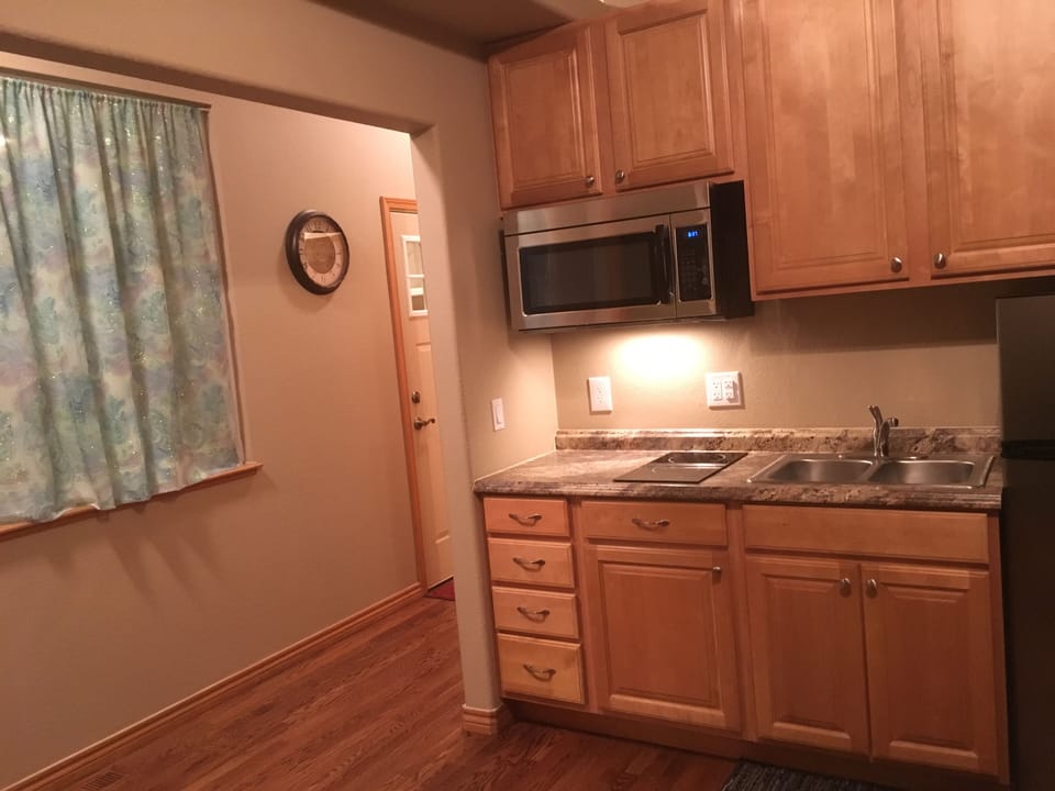 Kitchen has stove, microwave, fridge/freezer, crock pot, toaster, pots & pans.
