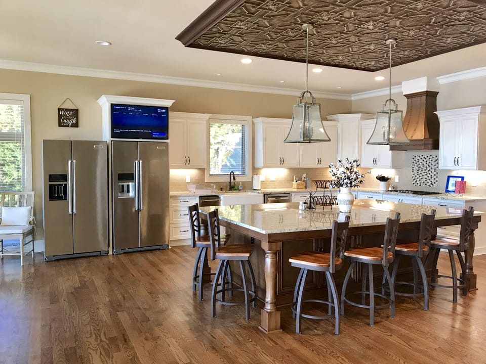 Main kitchen, large Island, double ovens, 3 refrigerators, bar area, lake views.