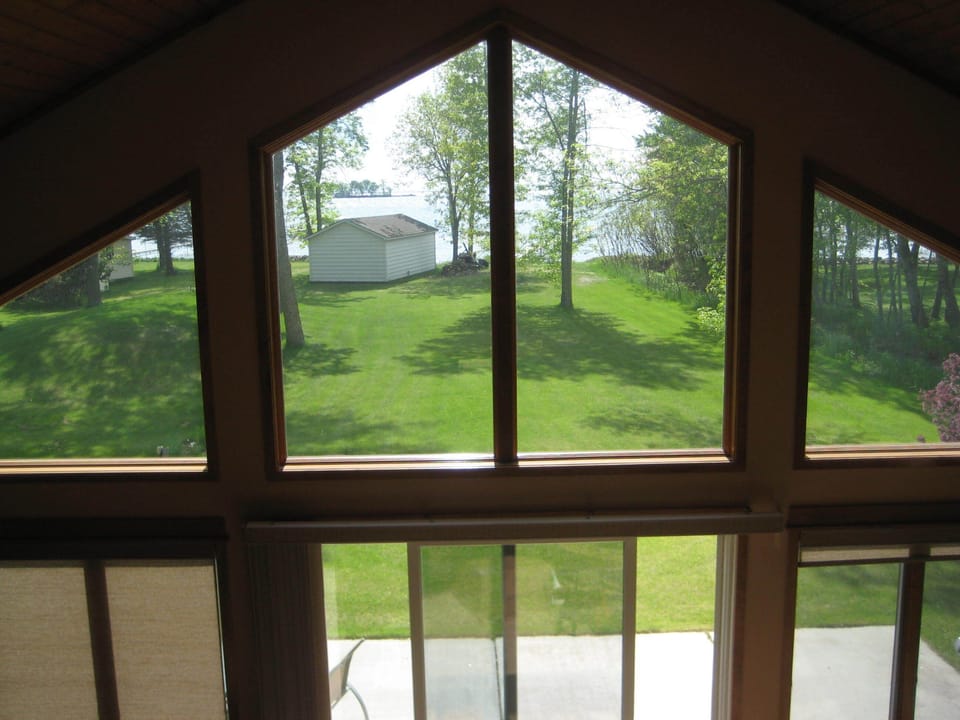 View of yard and lake from upstairs landing